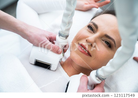 Woman receiving a skincare treatment in a spa environment during daytime 123117549