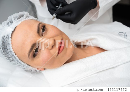 Woman receiving a cosmetic treatment in a modern spa environment Woman receiving a cosmetic treatment in a modern spa environment 123117552