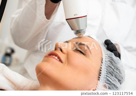 Woman receiving facial treatment in a spa during daytime Woman receiving facial treatment in a spa during daytime 123117554