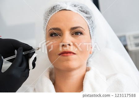 Woman receiving cosmetic treatment in a modern clinic setting 123117588