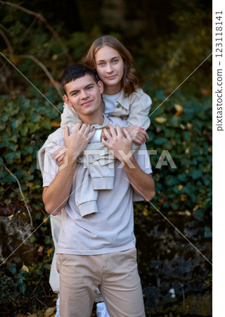 Embracing Teen Love in the Greenery of the Park. Whispers of Love: Teen Couple's Outdoor Embrace in the Park. Embracing Teen Love in the Greenery of the Park. Whispers of Love: Teen Couple's Outdoor Embrace in the Park. 123118141