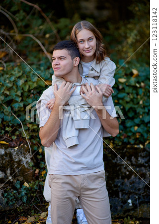 Teen couple in love in the park. Lovely young engaged couple embracing and smiling after kissing against sunset. Smooth Focus, Valentine couples walking. Lovers love concept. 123118142