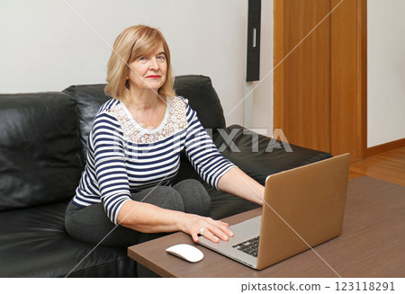 Mature woman using laptop 123118291