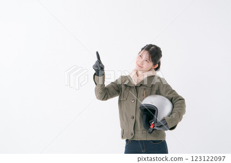 Female rider with helmet Female rider with helmet 123122097