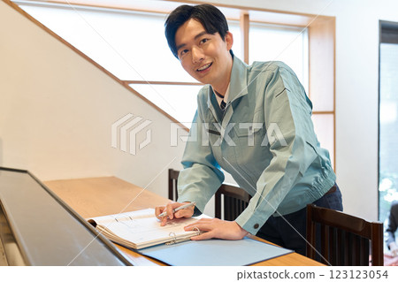 A man checking blueprints at a restaurant 123123054