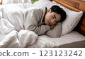 A young man sleeping lazily in bed 123123242