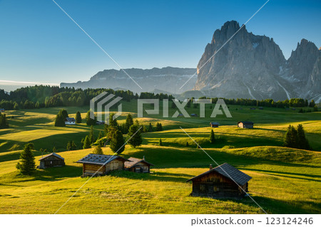 Chalets at Seiser Alm, high altitude meadow with Langkofel mountain in background at sunrise, Dolomites, South Tyrol, Italy Chalets at Seiser Alm, high altitude meadow with Langkofel mountain in background at sunrise, Dolomites, South Tyrol, Italy 123124246