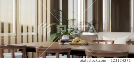 The wooden tabletop with decorative item contains a breakfast set, near the glass door with curtain. The wooden tabletop with decorative item contains a breakfast set, near the glass door with curtain. 123124271