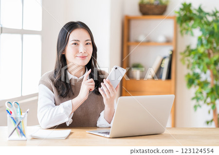 A young woman doing telework in the living room. 123124554