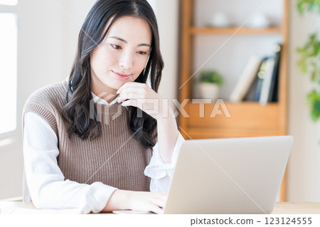 A young woman doing telework in the living room. A young woman doing telework in the living room. 123124555