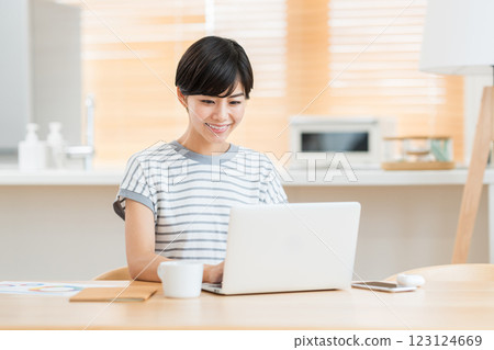 A woman teleworking in the living room. A woman teleworking in the living room. 123124669