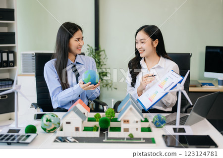 Group of diverse multiethnic businesspeople standing neare table looking at model of building from residential project. Group of diverse multiethnic businesspeople standing neare table looking at model of building from residential project. 123124781