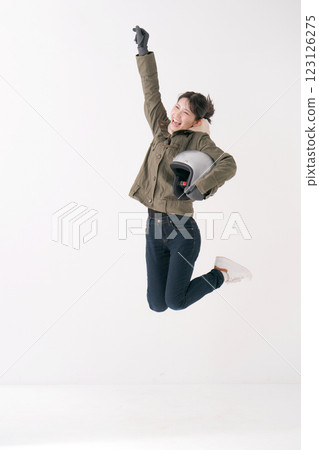 Jumping female rider 123126275