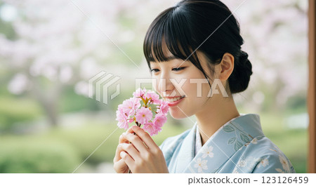 A woman enjoying the scent of flowers 123126459