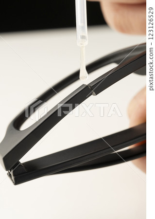Repairing a broken eyeglass frame with glue Repairing a broken eyeglass frame with glue 123126529