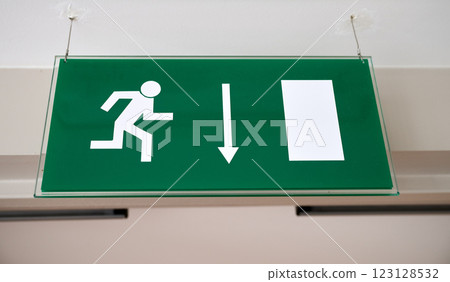 Green emergency sign indicate the right direction hanging Green emergency sign indicate the right direction hanging 123128532