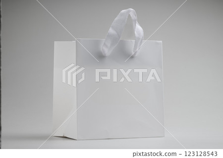 Clean white luxury paper bag in studio light on white background Clean white luxury paper bag in studio light on white background 123128543