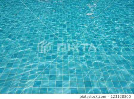 A blue tiled swimming pool floor with sunlight reflecting off the water (AI-generated image) A blue tiled swimming pool floor with sunlight reflecting off the water (AI-generated image) 123128800