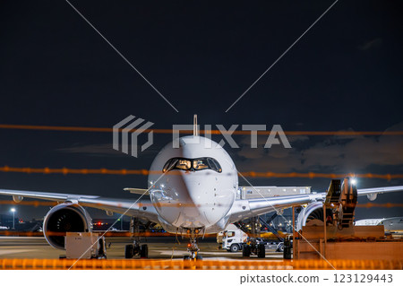 [#Airport] A plane parked at the airport at night 123129443