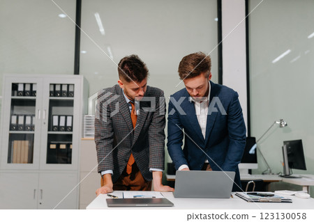 Diverse professionals collaborate on project analysis with financial graphs. 123130058