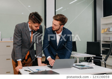 Diverse professionals collaborate on project analysis with financial graphs. 123130059