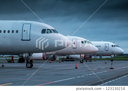 The noses of white passenger planes at the airport on an early cloudy morning The noses of white passenger planes at the airport on an early cloudy morning 123130218