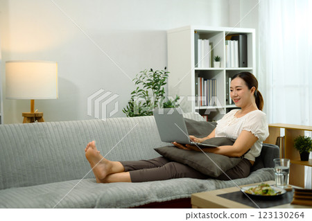 Smiling middle aged woman using her digital tablet to browse or watch content Smiling middle aged woman using her digital tablet to browse or watch content 123130264