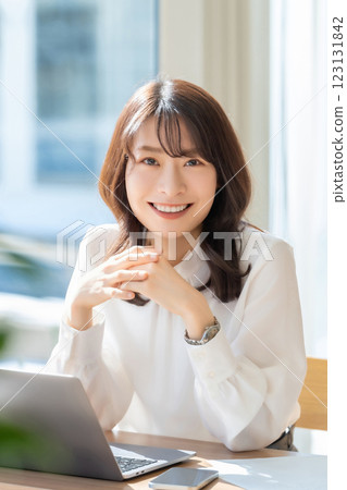 Smiling woman/businesswoman doing desk work Smiling woman/businesswoman doing desk work 123131842