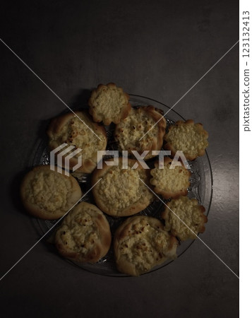 Delicious homemade pastries with cottage cheese filling resting on glass plate 123132413