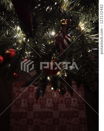 Christmas tree decorated with red and white ornaments and lights illuminating advent calendar 123132482