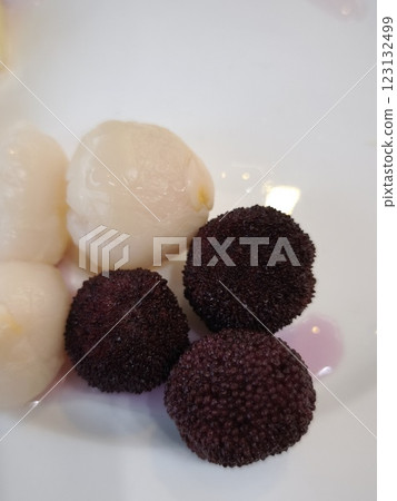 Fresh lychees and bayberries resting on white plate all you can eat 123132499
