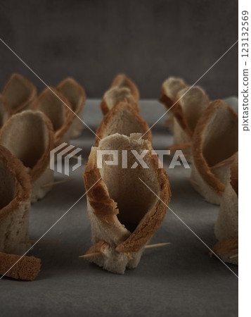 Preparing edible bread cups for christmas dinner using toothpicks party food for aperitif, New Year's Eve dinner, Christmas or birthday Preparing edible bread cups for christmas dinner using toothpicks party food for aperitif, New Year's Eve dinner, Christmas or birthday 123132569