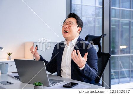 Stressed Businessman Reacting to Work Challenge at Office Desk Stressed Businessman Reacting to Work Challenge at Office Desk 123132927