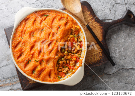 Low calorie Sweet Potato Shepherd's Pie with Turkey and Vegetables close-up in baking dish. Horizontal top view 123133672