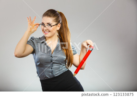 Teacher looking elegant woman holding big pencil 123133875