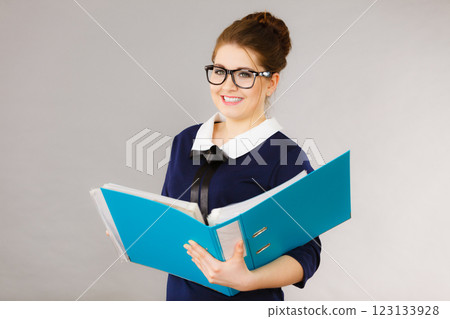 Happy positive business woman holding binder with documents 123133928