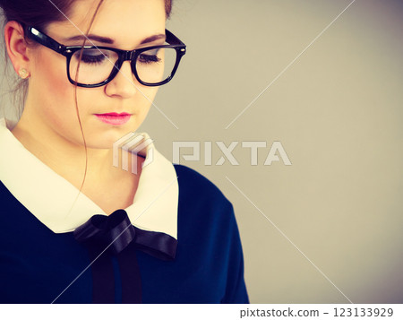 Focused business woman looking down thinking 123133929