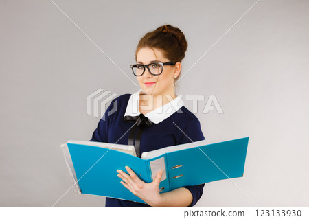 Happy positive business woman holding binder with documents 123133930