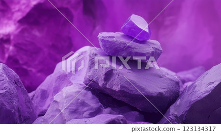 A purple rock with a smaller, identical one atop it against a backdrop 123134317