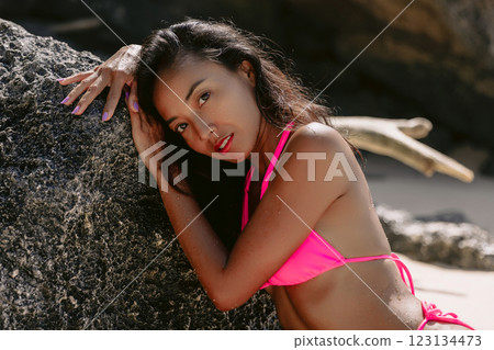 Beauty asian woman in bikini at beach. Pretty girl at ocean coastline Beauty asian woman in bikini at beach. Pretty girl at ocean coastline 123134473