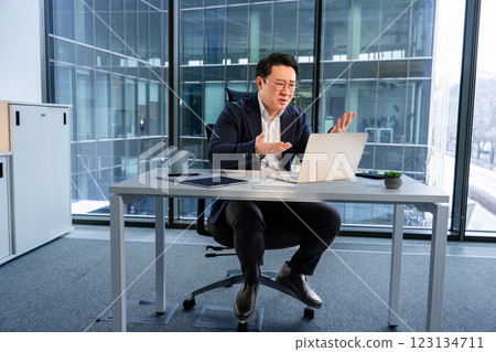 Professional Businessman Conducting Online Meeting From Modern Office Space 123134711