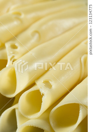Semi-hard cheese, thin slices, rolled into tubes. 123134775
