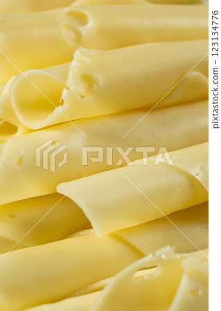 Semi-hard cheese, thin slices, rolled into tubes. Semi-hard cheese, thin slices, rolled into tubes. 123134776
