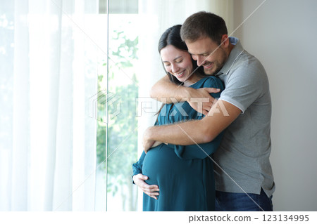 Asian pregnant woman and husband looking at belly 123134995