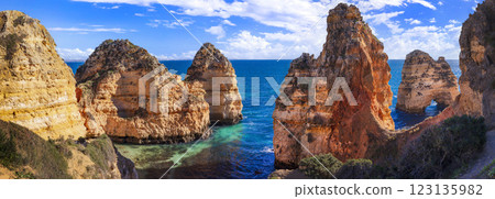 Amazing rocky scenic becahes of Algarve coast, Portugal. Breathtaking yellow rocks with arc . Amazing rocky scenic becahes of Algarve coast, Portugal. Breathtaking yellow rocks with arc . 123135982