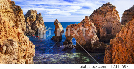 Amazing rocky scenic becahes of Algarve coast, Portugal. Breathtaking yellow rocks with arc . Amazing rocky scenic becahes of Algarve coast, Portugal. Breathtaking yellow rocks with arc . 123135983