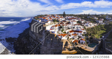Portugal travel and landmarks. Azenhas do mar - charming coastal village on the cliff . Aerial panoamic view of white houses and atlantic ocean Portugal travel and landmarks. Azenhas do mar - charming coastal village on the cliff . Aerial panoamic view of white houses and atlantic ocean 123135988
