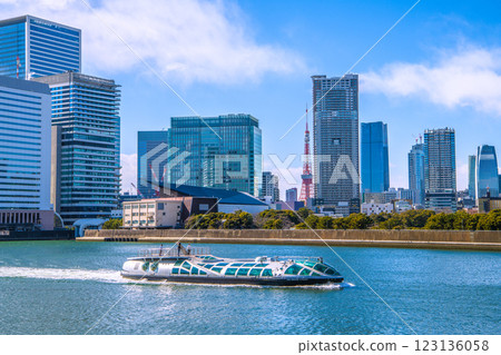New scenery of Tokyo cityscape in Japan. View of the water bus "Emeraldas", Takeshiba, Hamamatsucho, etc. Tokyo Tower and Azabudai in the background. New scenery of Tokyo cityscape in Japan. View of the water bus "Emeraldas", Takeshiba, Hamamatsucho, etc. Tokyo Tower and Azabudai in the background. 123136058