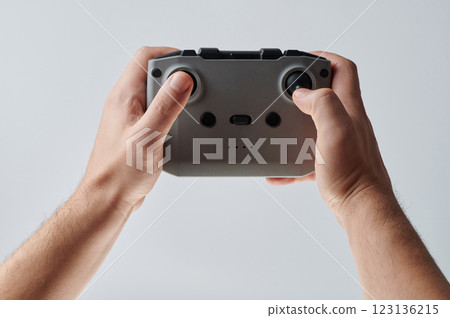 Gray remote control in hand Gray remote control in hand 123136215