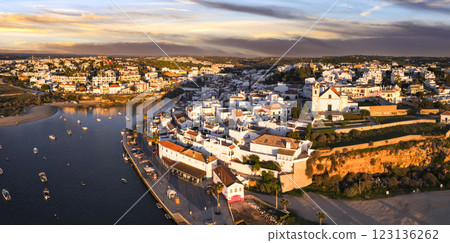 Ferragudo, Portugal: The Prettiest fishing traditional Village in  Algarve coast, near Portimao town. aerial high angle panoramic view over sunset 123136262